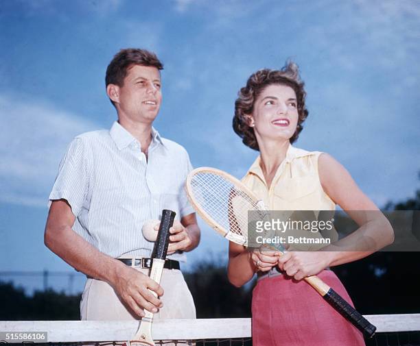 Senator John Kennedy and his fiancee Jacqueline Bouvier play tennis.
