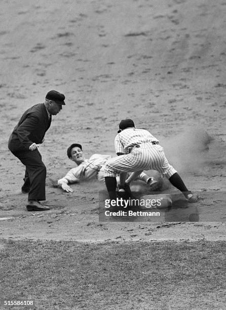 New York, NY: Stan Musial, St. Louis Cardinals outfielder, is shown sliding into third base on Walker Cooper's single to center field in the fourth...