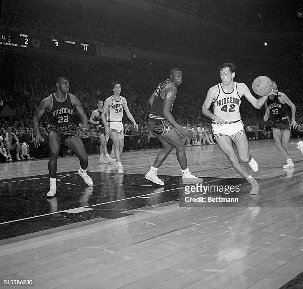 New York, NY- Princeton's Bill Bradley scoots around Michigan's Cazzie Russell at the ECAC Holiday Basketball Festival at Madison Square Garden....