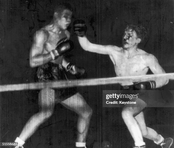 Welsh boxer Tommy Farr lands a blow to Joe Louis' face in the 14th round of a World Heavyweight Championship fight in New York, 31st August 1937....