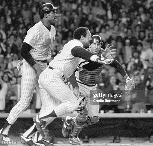 Reggie Jackson, of the New York Yankees, is shown charging to the mound to fight with John Denny of the Cleveland Indians.