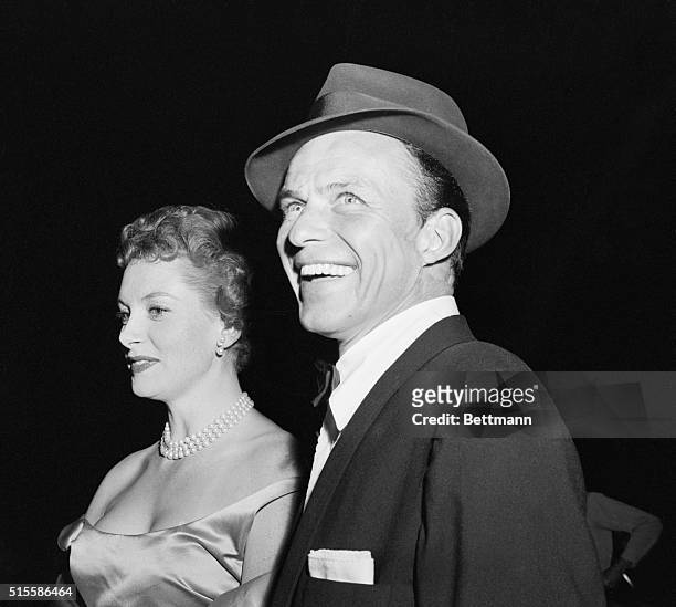 Hollywood, CA: A dapper, radiant Frank Sinatra, one of the stars of the film, arrives at this "Guys and Dolls" movie premiere with Deborah Kerr. Cleo...
