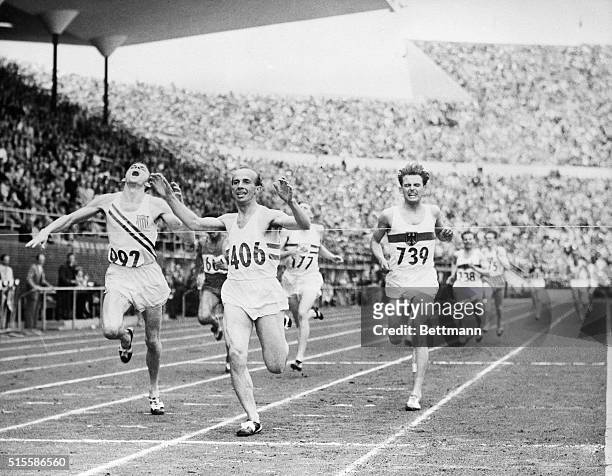 Joseph Barthel of Luxembourg flashes across the finish line to win the 1500-meter run final at Olympic Stadium, July, 26. Robert E. McMillen of the...