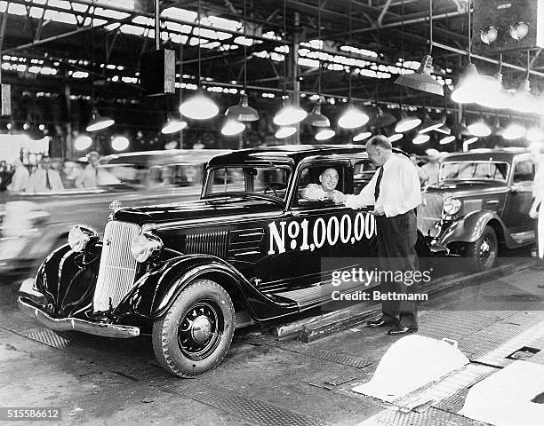 Company vice president B.E. Hutchinson shakes hands with founder Walter P. Chrysler in Detroit to celebrate the production of the millionth Plymouth...
