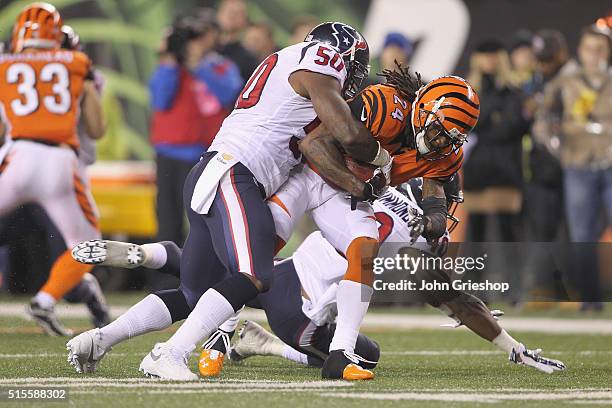 Adam Jones of the Cincinnati Bengals runs the football upfield against Akeem Dent of the Houston Texans during their game at Paul Brown Stadium on...