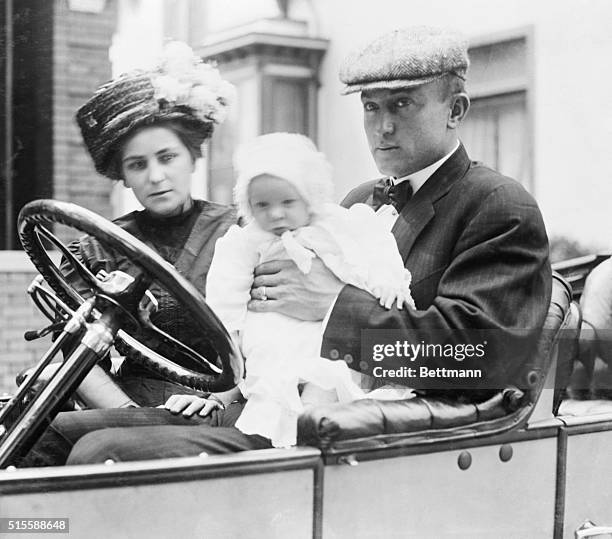 Mr. & Mrs. Ty Cobb and baby in Owen car. Ty is holding the child.