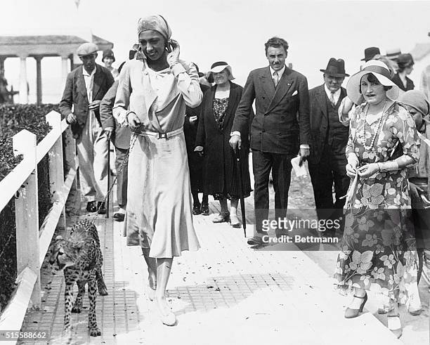 Deauville, France- Josephine Baker, colored American musical comedy star, as she gave Deauville a thrill by promenading with her latest pet, a baby...