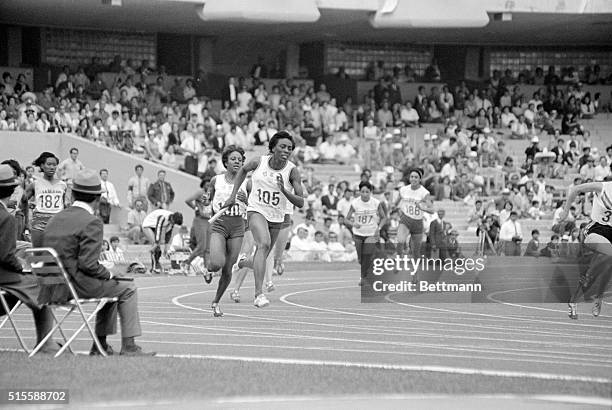 Mexico City, Mexico- Mildrette Netter of Rosedale, Mississippi passes the baton to teammate Myomia Tyus of Griffin, Georgia, during the women's...