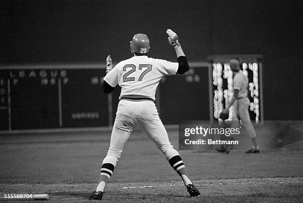 Boston, MA: After hitting in the twelfth inning, Boston's Carlton Fisk gestures at the flying ball, directing its path to a home run and a 7-6 win...