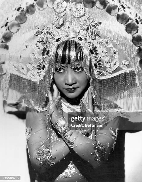 Anna May Wong wears one of the screen's most colorful costumes here, as the Oriental Princess and stage dancer in Paramount's 1931 film "Daughter of...
