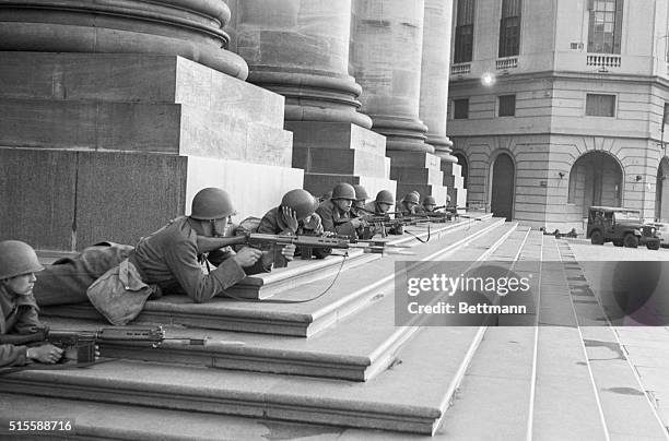 Argentine troops lay with rifles ready in the Plaza de Mayo across from the Presidential Palace, awaiting developments as a military coup ousts the...