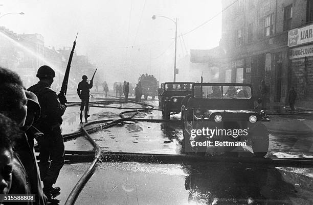 Chicago,IL- The Illinois National Guard patrol this riot-scarred area of the City's West side. Police say at least nine persons have been killed...
