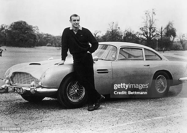 Actor Sean Connery, the original James Bond, is pictured here on the set of Goldfinger with one of the fictional spy's cars, a 1964 Aston Martin DB5.