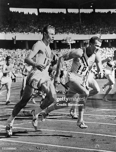 Melbourne, Australia- U.S.TEAM MAKES RELAY RECORD. Thane Baker, left, hands the baton to Bobby Morrow as the last baton change in the world...