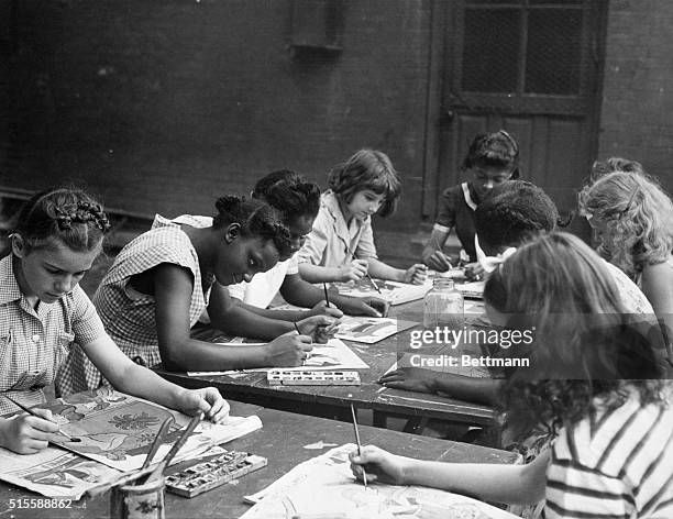 Philadelphia, PA: Negro and white children work together on posters as part of program prepared by the American Junior Red Cross in the Southeastern...
