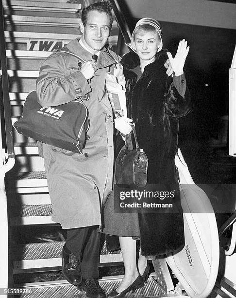 New York, NY- Newlyweds Paul Newman and Joanne Woodward, two of Hollywood's most promising young stars, prepare to board a TWA Jetstream flight to...