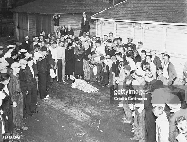 Crowd surrounds the covered body of John Dillinger gangster Homer Van Meter, who was killed after fleeing police in St. Paul, Minnesota.