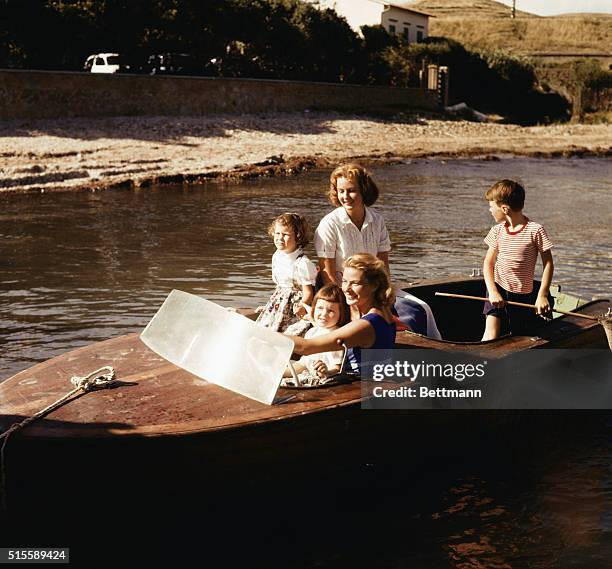 Actress Ingrid Bergman drives a motor boat with her son, Roberto Rossellini; the twins, Isabella and Isotta Rossellini; and her eldest daughter, Pia...