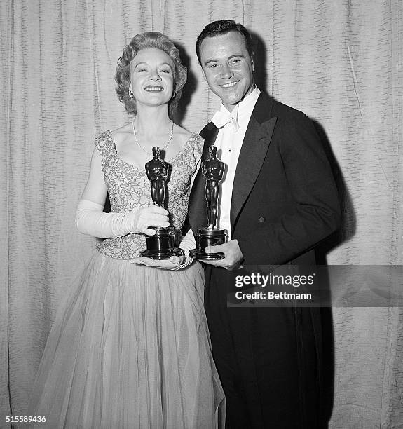 Hollywood, CA- Jo Van Fleet and Jack Lemmon pose happily with their "Oscars" after winning the awards as Best Supporting Actress and Best Supporting...