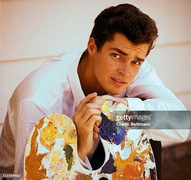 Richard Beymer posing for a publicity handout with a painter's palette. Beymer starred as Tony in the film West Side Story.