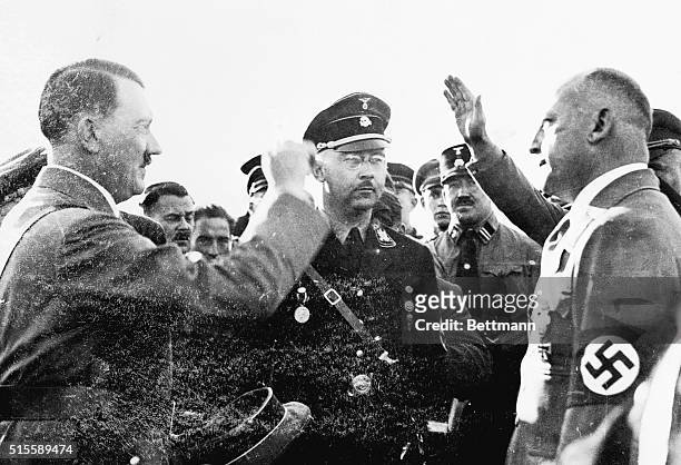 Herr Wagner, , Bavarian Minister of Interior, greets, Chancellor-Leader Adolph Hitler, left, and Herr Himmler, center, the head of the Schutz...