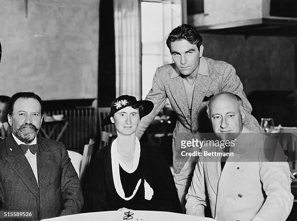 Sir Henry Wood, noted English Symphonic conductor, and his wife, Lady Wood, in Hollywood to conduct concerts at the Hollywood Bowl, take lunch at the...