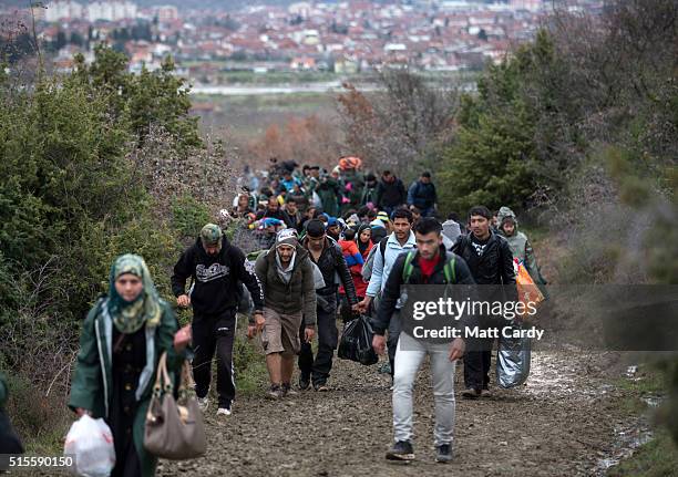 Migrants trek towards Macedonia after leaving the Idomeni refugee camp, on March 14, 2016 in Idomeni, Greece. The decision by Macedonia to close its...