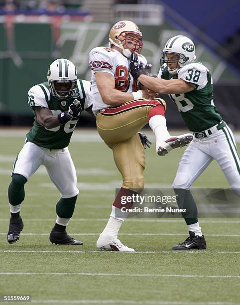 John McGraw and CB David Barrett of the New York Jets break up a pass intended for TE Eric Johnson of the San Francisco 49ers in the game on October...