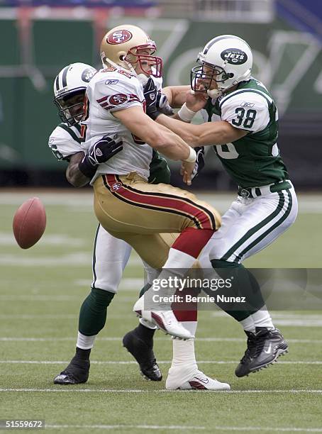 John McGraw and CB David Barrett of the New York Jets break up a pass intended for TE Eric Johnson of the San Francisco 49ers in the game on October...