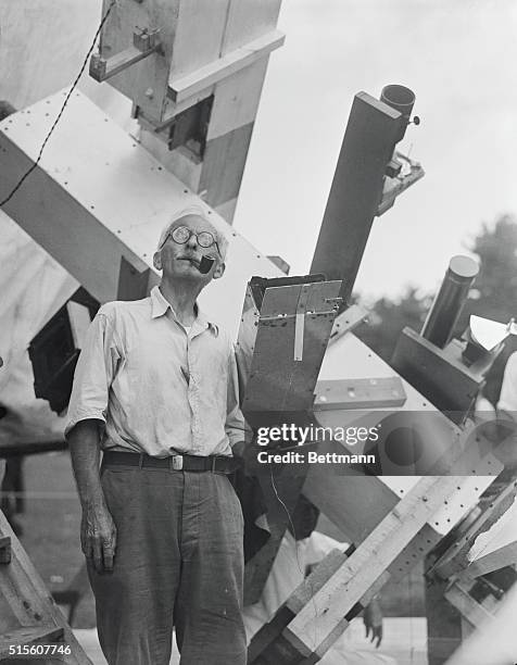 Dr. Herber Curtis, in charge of the University of Michigan camp, at position of the 34 inch concave grading spectrograph, operating shutter.