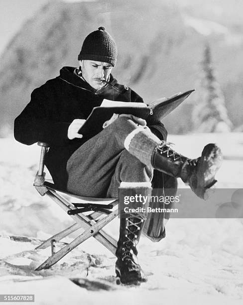 Director "Wild Bill" Wellman, in charge of a company which he is directing in the filming of The Call of the Wild amid the towering peaks of Mount...