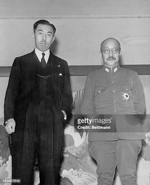 Prince Fumimaro Konoye , outgoing premier and General Hideki Tojo, the new one, pose for the camera following a transfer of State affair.