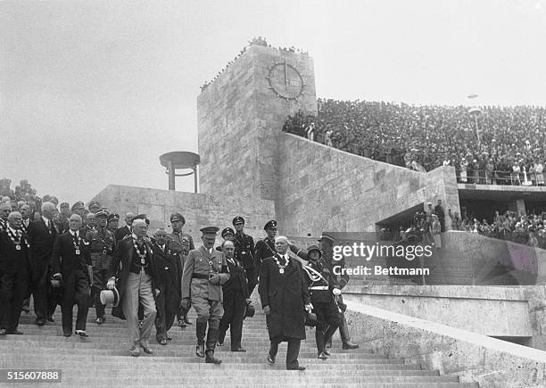 Reischfuhrer Adolf Hitler, is shown leading Olympic officials into the Olympic Stadium at Berlin, for the inauguration of the 1936 games. On the...