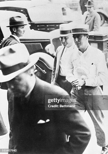 Alvin Karpis is shown at the right, coatless, on his arrival at the Federal Building in St. Paul, Minnesota, at the end of an airplane trip from New...
