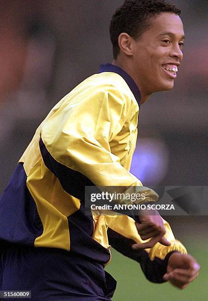 Ronaldinho Gaucho of the Brazilian soccer team jokes with teammates during a practice 25 July, 2000 in Sao Paulo, Brazil. Ronaldinho Gaucho, del...