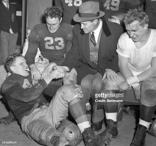 Coach Frank Leahy, , shakes hands here with Bernie Crimmins, the star guard of the first Notre Dame team since Rockne's 1930 team, to finish...
