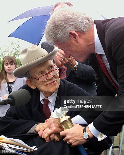 President Bill Clinton shakes hands with Justin Dart, Jr. A 1998 recipient of the Presidential Medal of Freedom prior to addressing the 10th...
