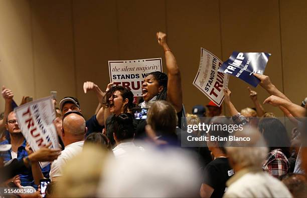 Protestors are removed from the Tampa Convention Center as Republican presidential candidate Donald Trump speaks to supporters during a town hall...