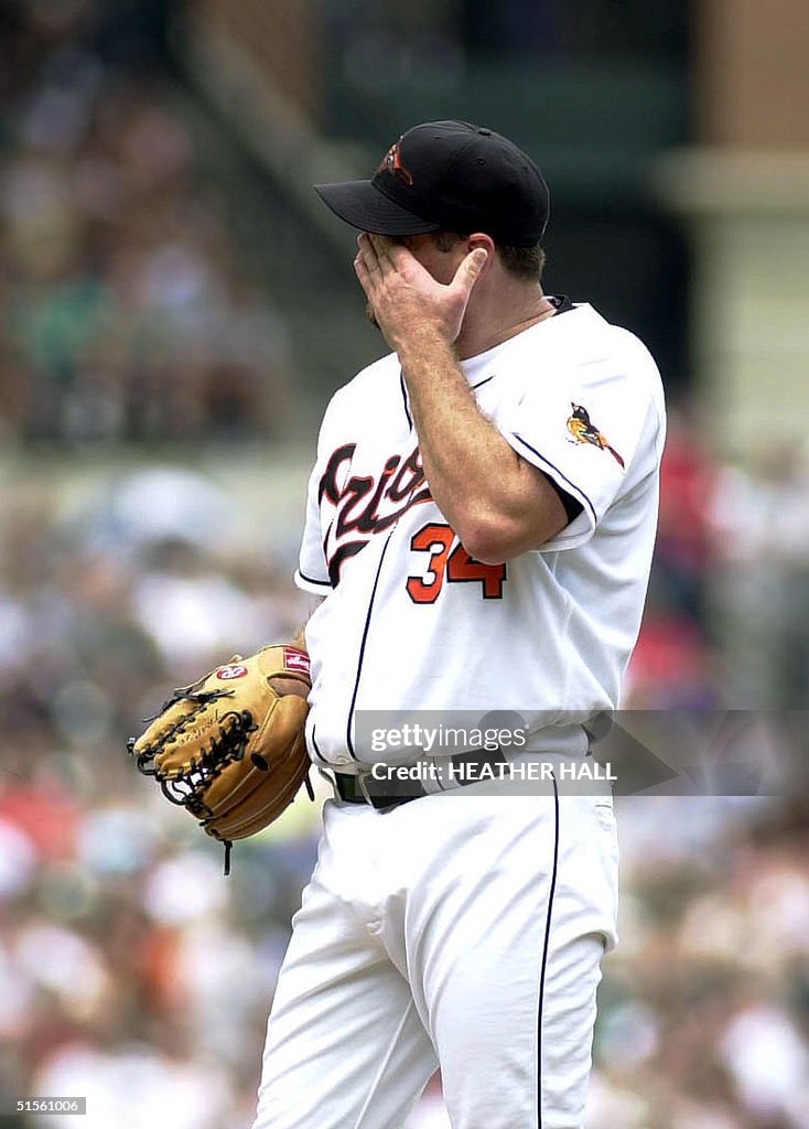Baltimore Oriole pitcher Pat Rapp wipes his brow after giving up his ...