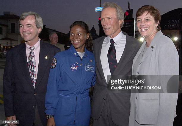 Actor Clint Eastwood poses with NASA advisors Dr. Peach , Yvonne Gagle, Catherine Clarke, as he arrives at the premiere of his new film "Space...