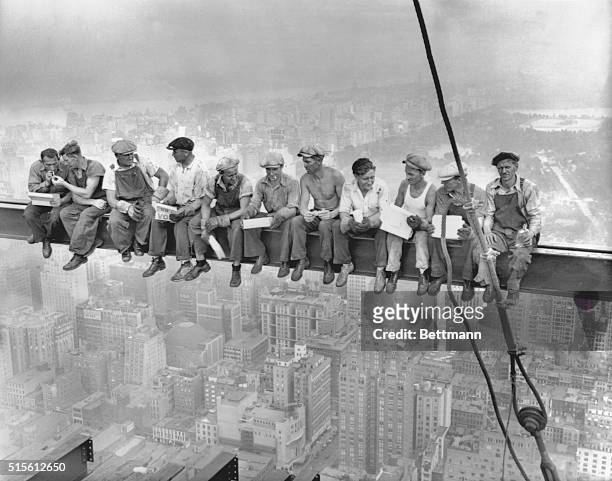 While New York's thousands rush to crowded restaurants and congested lunch counters for their noon day lunch, these intrepid steel workers atop the...