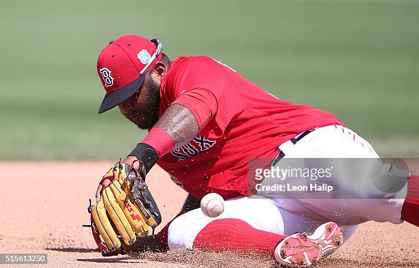 Pablo Sandoval of the Boston Red Sox knocks the ball down at third base on the ground ball from Jason Rogers of the Pittsburgh Pirates an makes the...