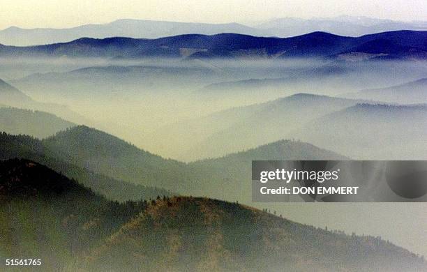 Smoke fills the mountain valleys south of Missoula, MT 09 August 2000, as visibility on the ground in large areas south of Missoula is approximately...