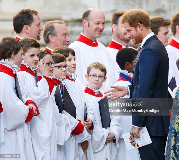 Prince Harry talks with choir boys as he attends the Commonwealth Observance Day Service at Westminster Abbey on March 14, 2016 in London, England....