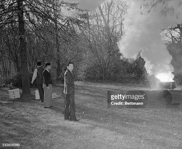 Members of the staff of the Japanese Embassy in Washington, burn papers and documents in back yard of that building, December 7th, after their...