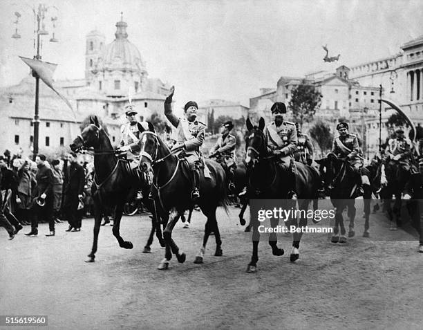 Mussolini Celebrates 10th year of Power. Rome: Smiling and saluting from his horse, Mussolini inaugurates the "Via of Impero" which leads to the...