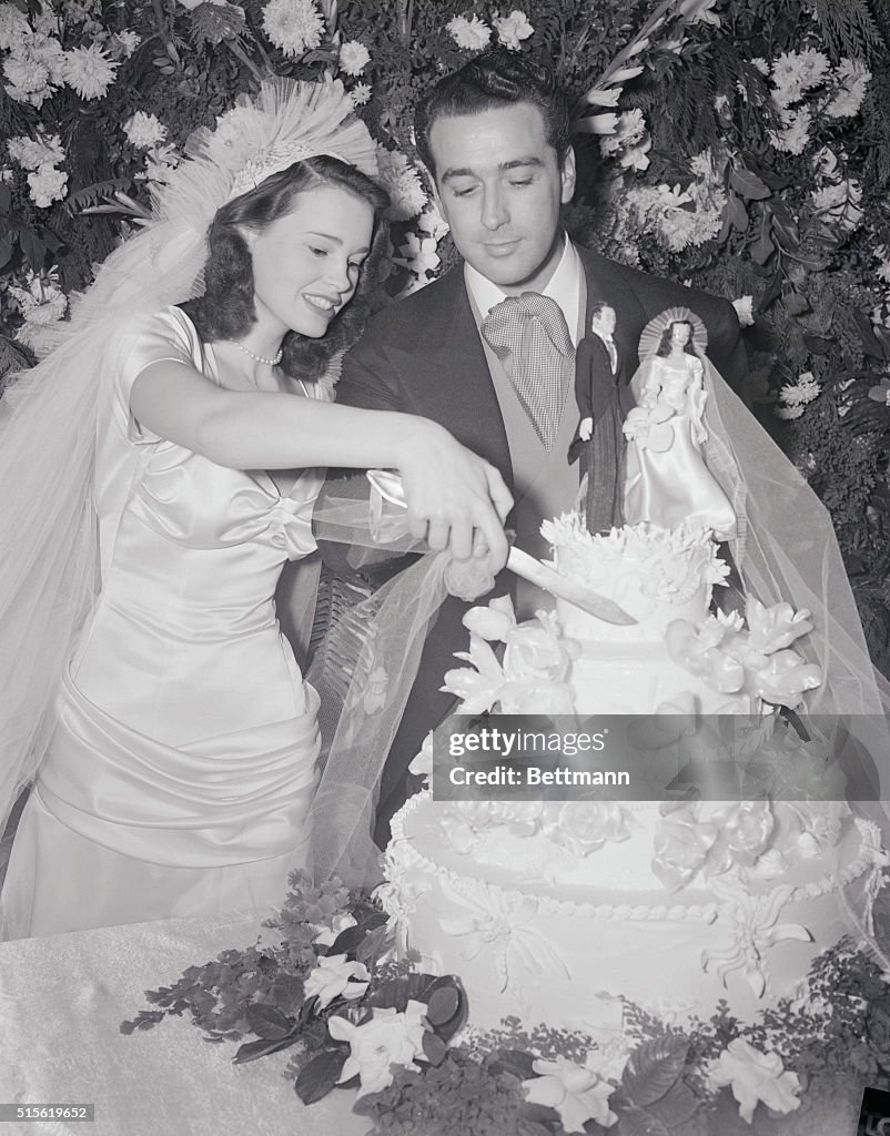 Gloria Vanderbilt DiCicco and Pasquale DiCicco Cutting Wedding Cake