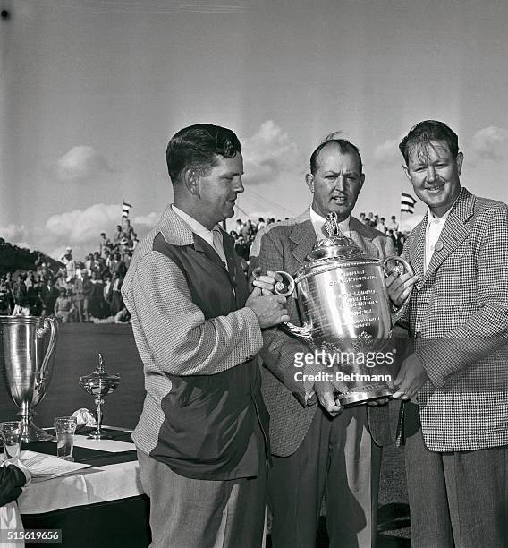 Byron Nelson , winner in the National PGA Tourney at Dayton, Ohio, receives the huge cup from Ed Dudley PGA Tourney president, as Sam Byrd,...