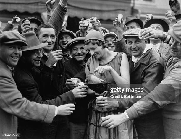 Egg Harbor is shown...and happy is not used in its usual disparaging sense in designating the bubbling wine that this French Miss, Mildred Norman is...