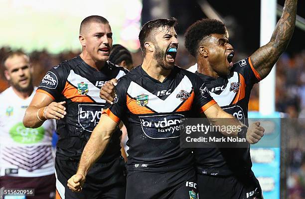 James Tedesco of the Tigers celebrates his third try with team mates during the round two NRL match between the Wests Tigers and the Manly Sea Eagles...